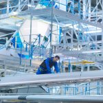 Engineer working on aircraft wing in aircraft maintenance in an FAA Repair Station Falicity.jpg